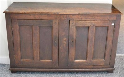 Lot 1663 - An 18th century joined oak two-door cupboard, with fielded panel doors and plinth base raised...