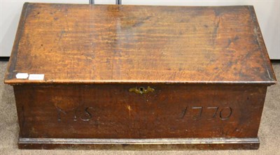 Lot 1666 - An 18th century oak chest of small proportions, with hinged lid above a front panel carved 'MS' and