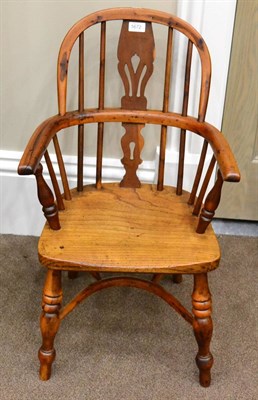 Lot 1672 - A 19th century child's yew wood Windsor armchair, the double spindle back with pierced splat...