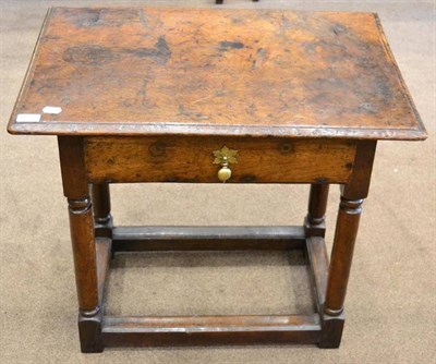 Lot 1678 - An early 18th century side table, the moulded top above a single frieze drawer, raised on gun...