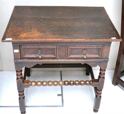 Lot 1681 - An English joined oak side table, circa 1700, the pleated top above two moulded drawers, raised...