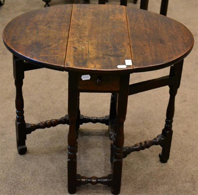 Lot 1684 - An early 18th century oak drop leaf table of small proportions with a single drawer raised on...