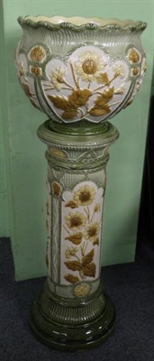 Lot 21 - A Burmantofts Pottery Jardiniere and Stand, circa 1900, moulded with panels of flowering...
