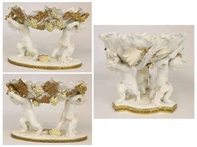 Lot 25 - A Moore Glazed Parian Three Piece Garniture, circa 1880, modelled as shells supported by putti...