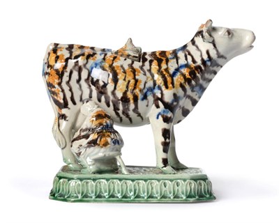 Lot 52 - A Pearlware Cow Creamer and Stopper, circa 1790, the standing beast with blue, ochre and...