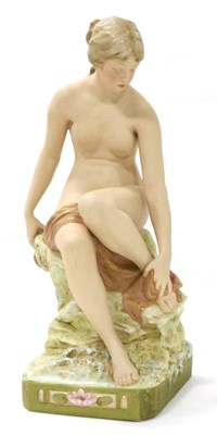 Lot 53 - A Royal Dux Bisque Porcelain Figure of a Bather, early 20th century, sitting on a rock drying...