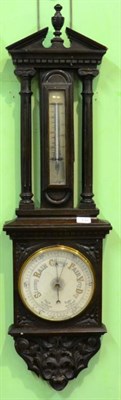 Lot 130 - An Oak Aneroid Barometer, circa 1900, broken arched pediment, thermometer tube, 8-inch pottery...