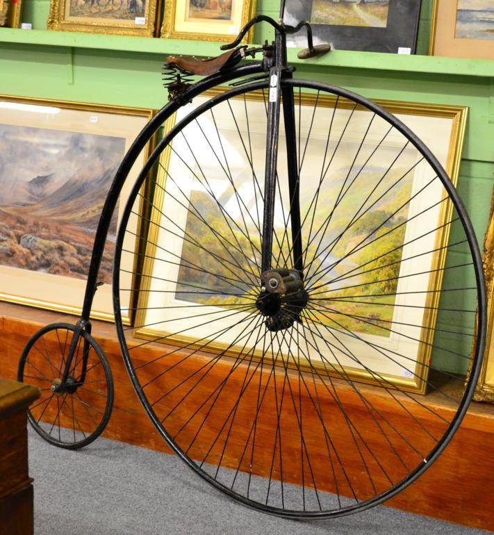 Lot 1163 - A Vintage Penny Farthing Bicycle, in unrestored condition, with brown leather seat and coiled...