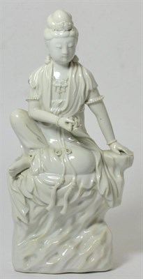 Lot 35 - A Chinese Blanc de Chine Figure of Guanyin, Qing Dynasty, sitting on a rocky outcrop, 50cm high