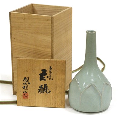 Lot 77 - A Japanese Celadon Glazed Bottle Vase, 20th century, moulded with leaf shaped panels, seal...