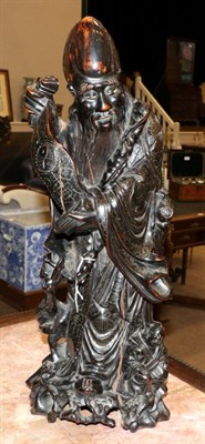 Lot 78 - A Chinese Rootwood Carving of a Sage, late Qing Dynasty, standing wearing flowing robes, an acolyte