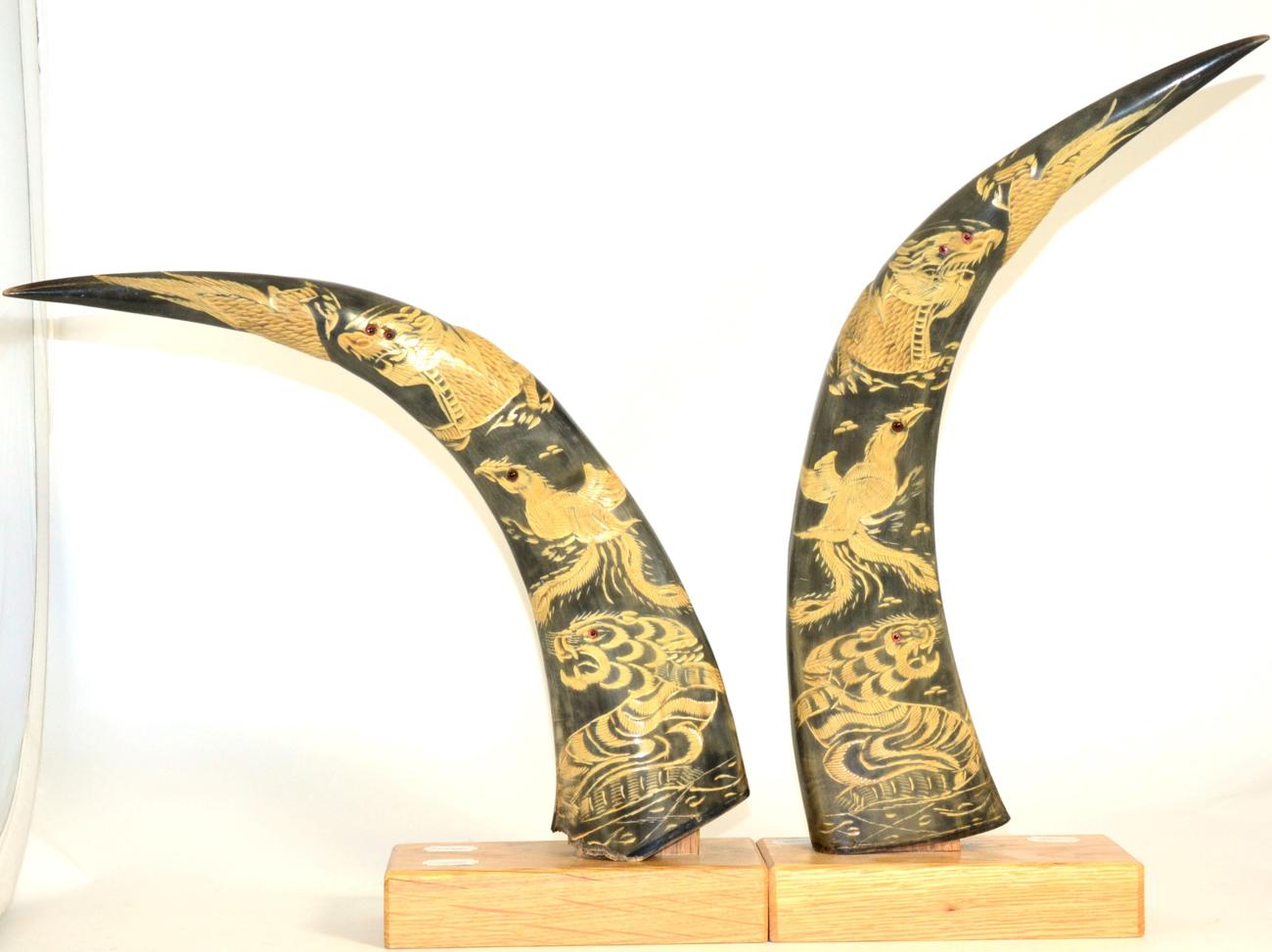 Lot 84 - A Pair of Chinese Bovine Horns, 20th century, carved with various animals with inlaid eyes, 50cm