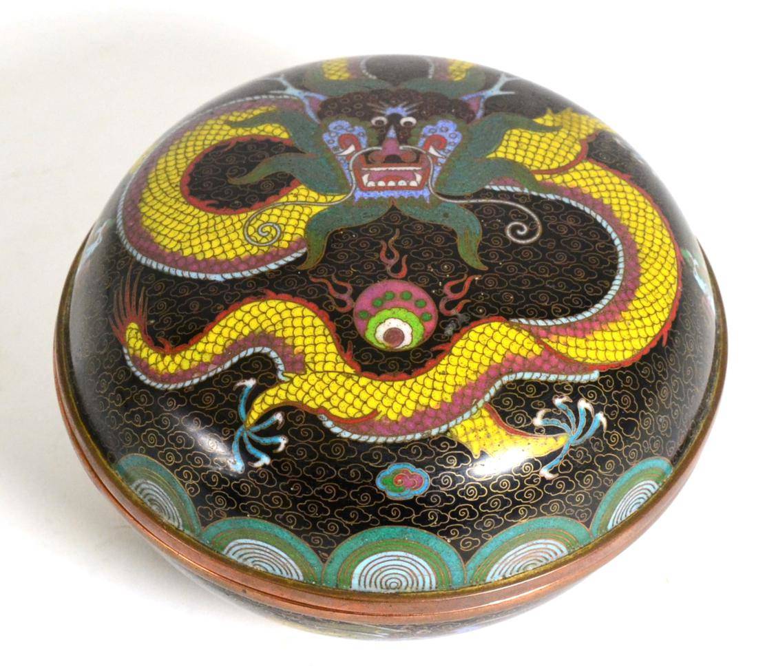 Lot 95 - A Chinese Cloisonné Circular Box and Cover, Qing Dynasty, decorated with a dragon on a dark...