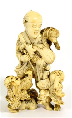 Lot 107 - A Japanese Ivory Okimono, Meiji period, as a boy with a monkey on his shoulder, two children at his