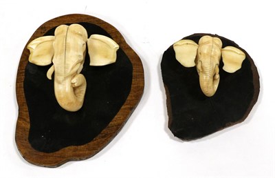 Lot 117 - A Pair of Japanese Ivory Models of Elephants' Heads, early 20th century, naturalistically modelled