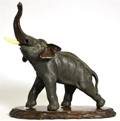Lot 118 - A Japanese Bronze Figure of an Elephant, Meiji period, standing with trunk raised and with...