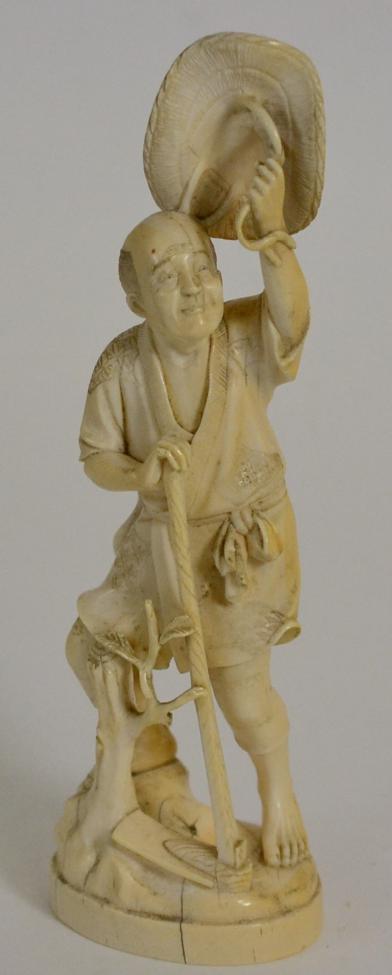 Lot 119 - A Japanese Ivory Okimono, Meiji period, as a farmer holding his hat above his head, signed,...