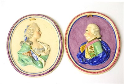 Lot 189 - A Pair of Staffordshire Portrait Medallions, early 19th century, moulded and painted with bust...