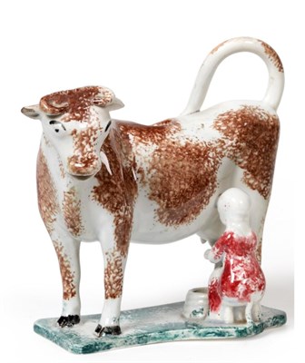 Lot 193 - A Pearlware Cow Creamer, circa 1820, the standing beast with brown sponged markings, a milkmaid...