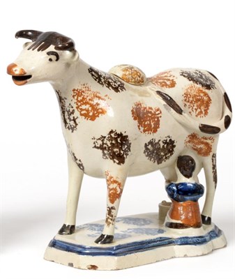 Lot 194 - A Pratt Type Pottery Cow Creamer, circa 1810, the standing beast with brown markings, a seated...