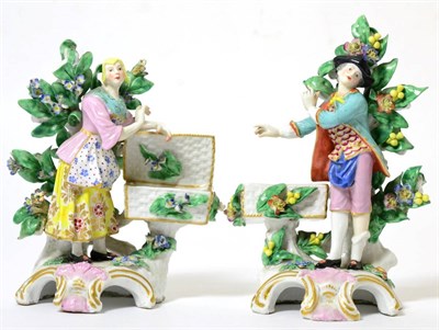 Lot 202 - A Pair of Chelsea Style Porcelain Sweetmeat Figures, circa 1900, as 18th century figures...