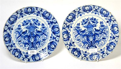 Lot 230 - A Pair of Dutch Delft Plates, early 18th century, painted in blue with a basket of flowers on a...
