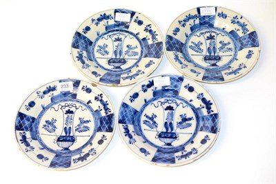 Lot 233 - A Set of Four Delft Plates, early 18th century, painted in blue in Kangxi style with a basket...