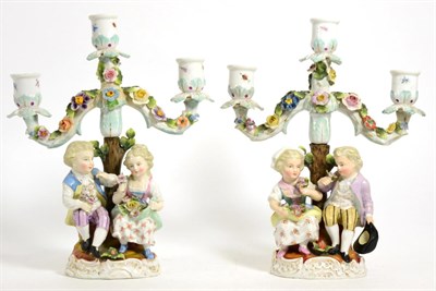 Lot 264 - A Pair of Sitzendorf Porcelain Figural Candelabra, circa 1900, with three lights on foliate...