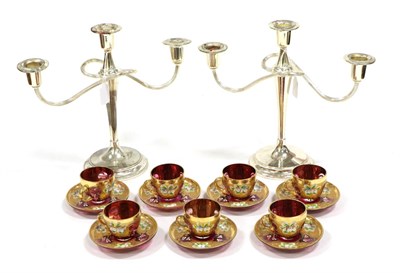 Lot 267 - A Set of Seven Bohemian Ruby Glass Coffee Cups and Saucers, early 20th century, painted with flower