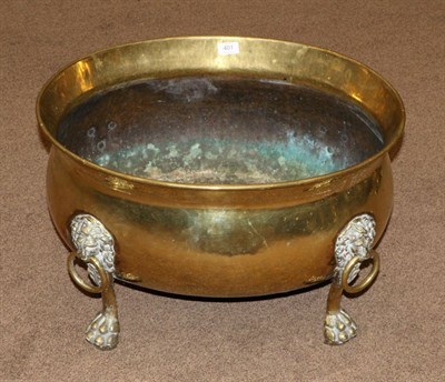 Lot 401 - A 19th Century Oval Brass Log Bin, in Regency style, with four lion mask loop handles and raised on