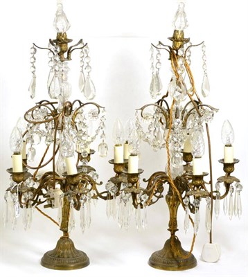 Lot 414 - A Pair of Gilt Metal and Glass Five-Light Candelabra, in George III style, with scroll branches...