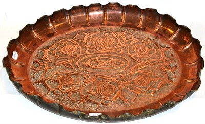 Lot 445 - An Arts & Crafts Style Tray, of fluted oval form, repoussé with stylised pomegranates, 65cm wide