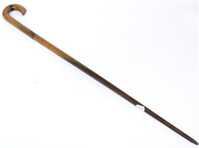 Lot 493 - A Rhinoceros Horn Walking Stick, circa 1900, with scroll handle, 87cm long