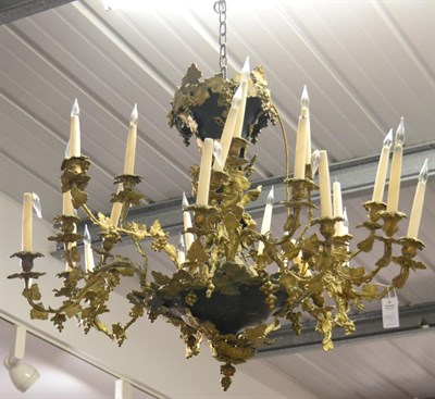 Lot 537 - A Gilt and Patinated Metal Twenty-Four Light Chandelier, cast and applied with Bacchic figures...