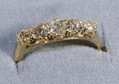 Lot 597 - An 18 Carat Gold Diamond Five Stone Ring, graduated old cut diamonds in claw settings, total...