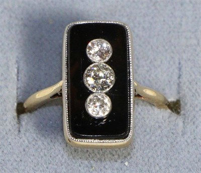 Lot 601 - An Art Deco Onyx and Diamond Ring, three graduated old cut diamonds in milgrain settings to a...