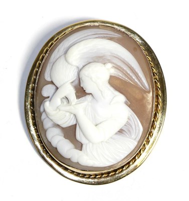 Lot 606 - A Carved Shell Cameo Brooch, depicting Hebe and Zeus, in an oval rope frame, measures 5.7cm by 5cm