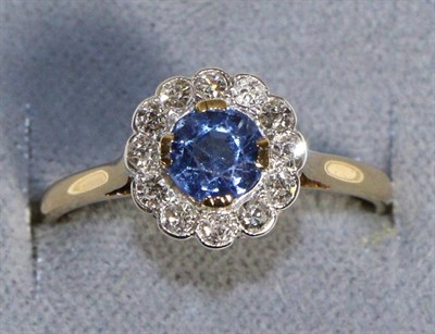 Lot 612 - A Sapphire and Diamond Cluster Ring, a round cut sapphire within a border of eight-cut diamonds, to