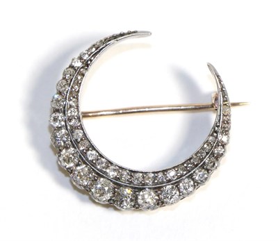 Lot 618 - A Diamond Crescent Brooch, two rows of graduated old cut diamonds, total estimated diamond...