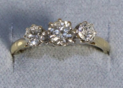 Lot 628 - A Three Stone Diamond Ring, graduated old cut diamonds in claw settings, to knife edge...