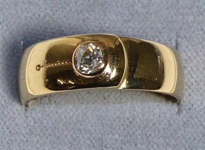 Lot 631 - An 18 Carat Gold Solitaire Diamond Band Ring, an old cut diamond in a rubbed over setting, to a...