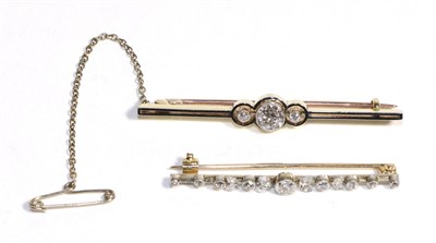 Lot 632 - A Diamond Bar Brooch, three graduated old cut diamonds in milgrain settings to pierced circular...