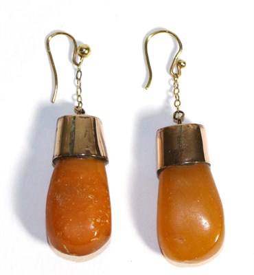 Lot 639 - A Pair of Amber Earrings, amber drops to rose coloured mounts, suspended from chains to hook...