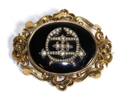 Lot 651 - A Victorian Onyx and Seed Pearl Mourning Brooch, an oval onyx plaque with an applied seed pearl...