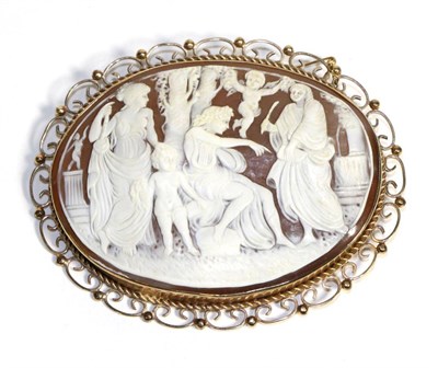 Lot 653 - A 9 Carat Gold Cameo Brooch, carved depicting Apollo with attendants and putti, in a rope and...