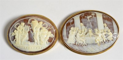 Lot 654 - A Carved Shell Cameo Brooch, depicting the Last Supper, measures 5.5cm by 7cm and a Second...