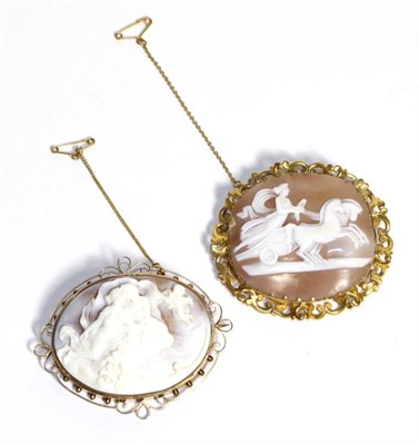 Lot 655 - A Carved Shell Cameo Brooch, depicting Cupid and Psyche, in a pierced scroll frame, measures 5cm by