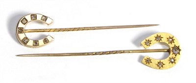 Lot 658 - A Diamond Horse Shoe Stick Pin, star set with graduated old cut diamonds, total estimated...