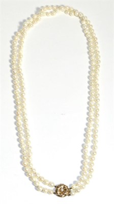 Lot 662 - A Double Strand Cultured Pearl Necklace, uniform cultured pearls knotted to a 9 carat gold...