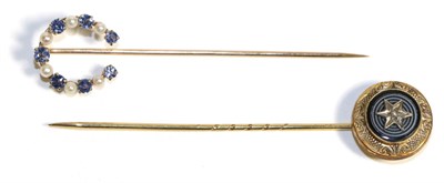 Lot 666 - A Sapphire and Seed Pearl Horseshoe Stick Pin, formed of alternating round cut sapphires and...